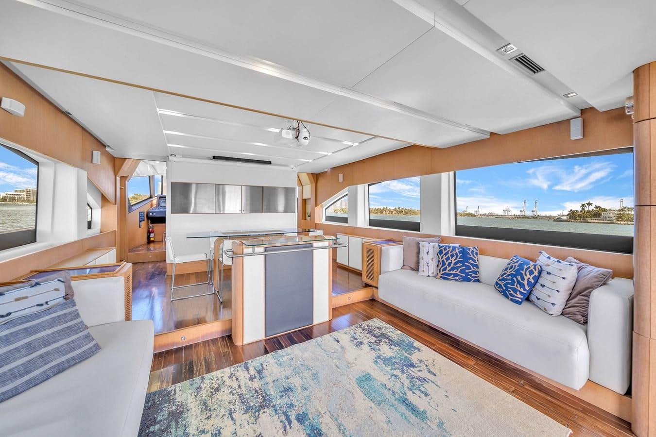 a large living room with a large blue rug and a large blue rug aboard AICON 85 Yacht for Sale