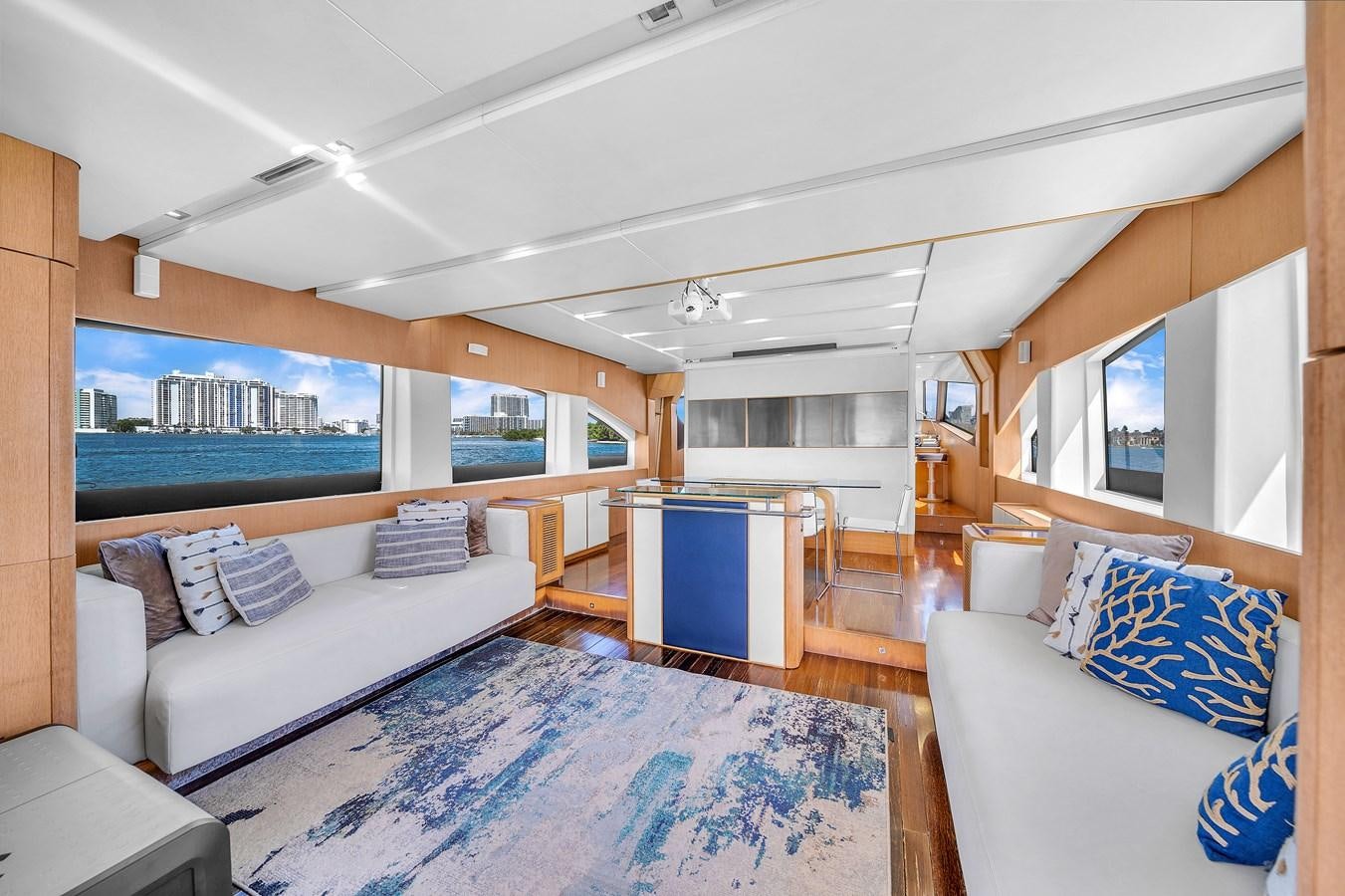 a living room with a blue rug aboard AICON 85 Yacht for Sale