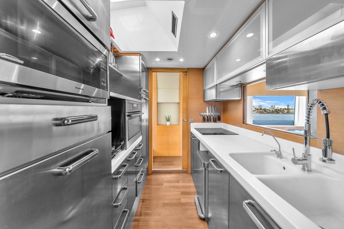 a kitchen with stainless steel appliances aboard AICON 85 Yacht for Sale