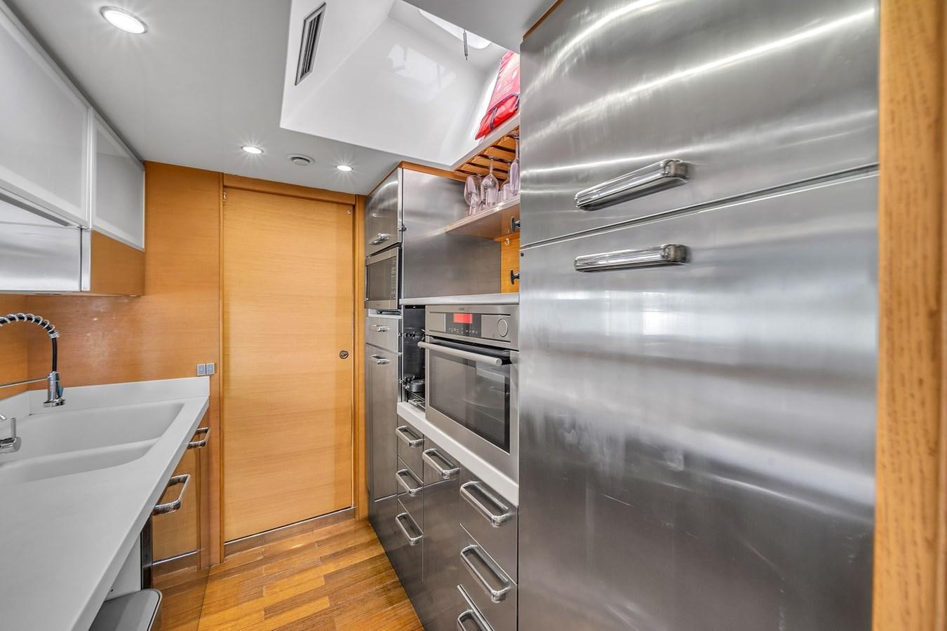 a kitchen with stainless steel appliances aboard AICON 85 Yacht for Sale
