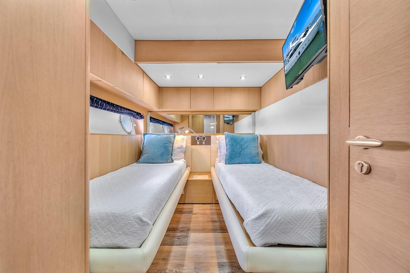 a room with a bed and a television on the wall aboard AICON 85 Yacht for Sale