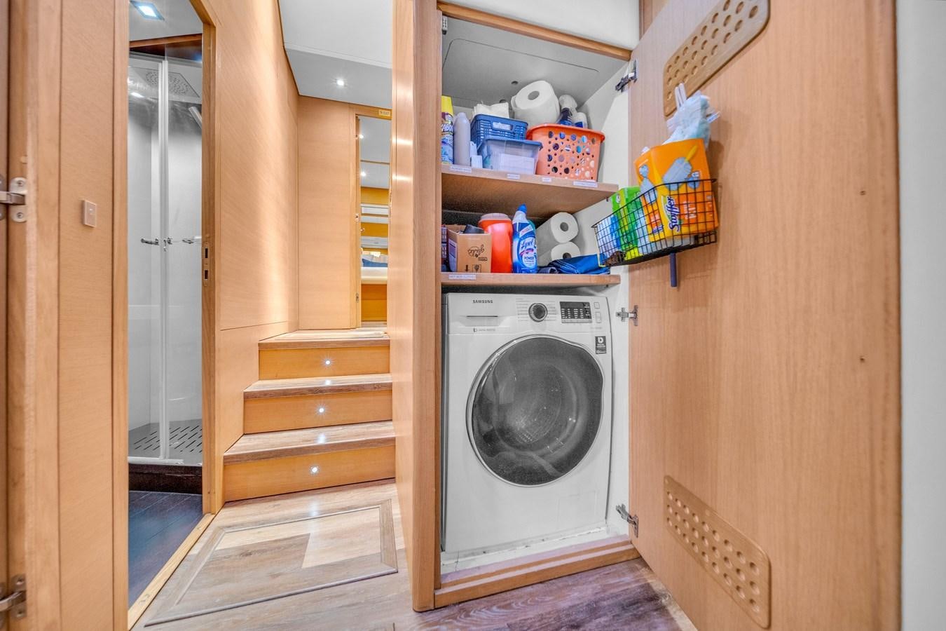 a small laundry room with a dryer and a closet aboard AICON 85 Yacht for Sale