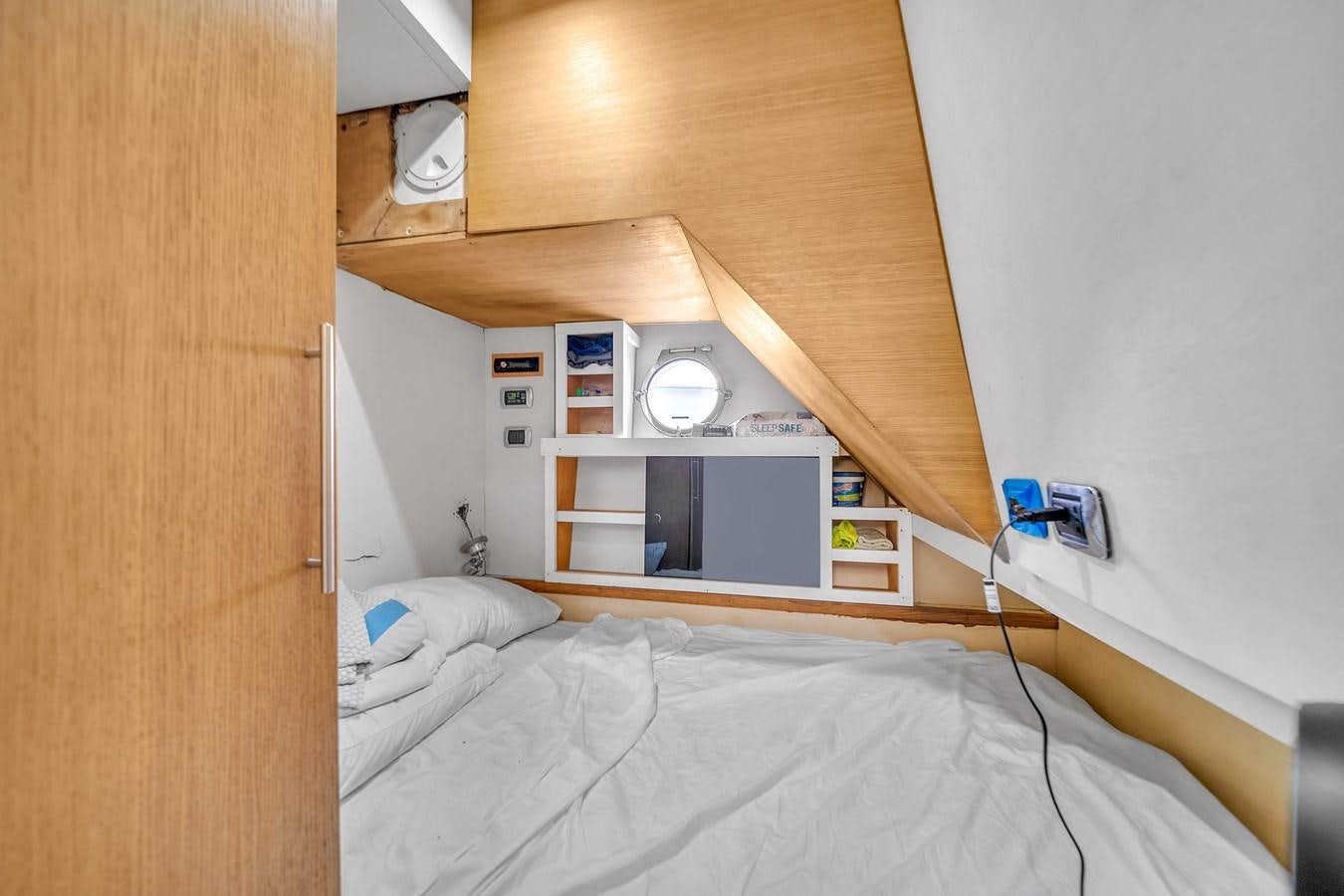 a bed with a white bed and a white shelf with a white wall aboard AICON 85 Yacht for Sale