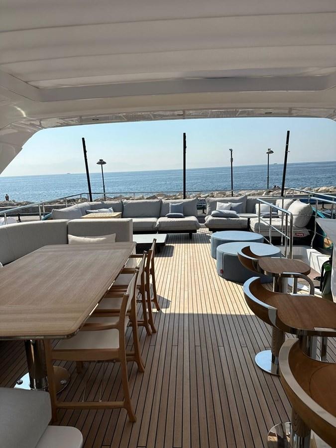 a deck with tables and chairs aboard BETTY Yacht for Sale