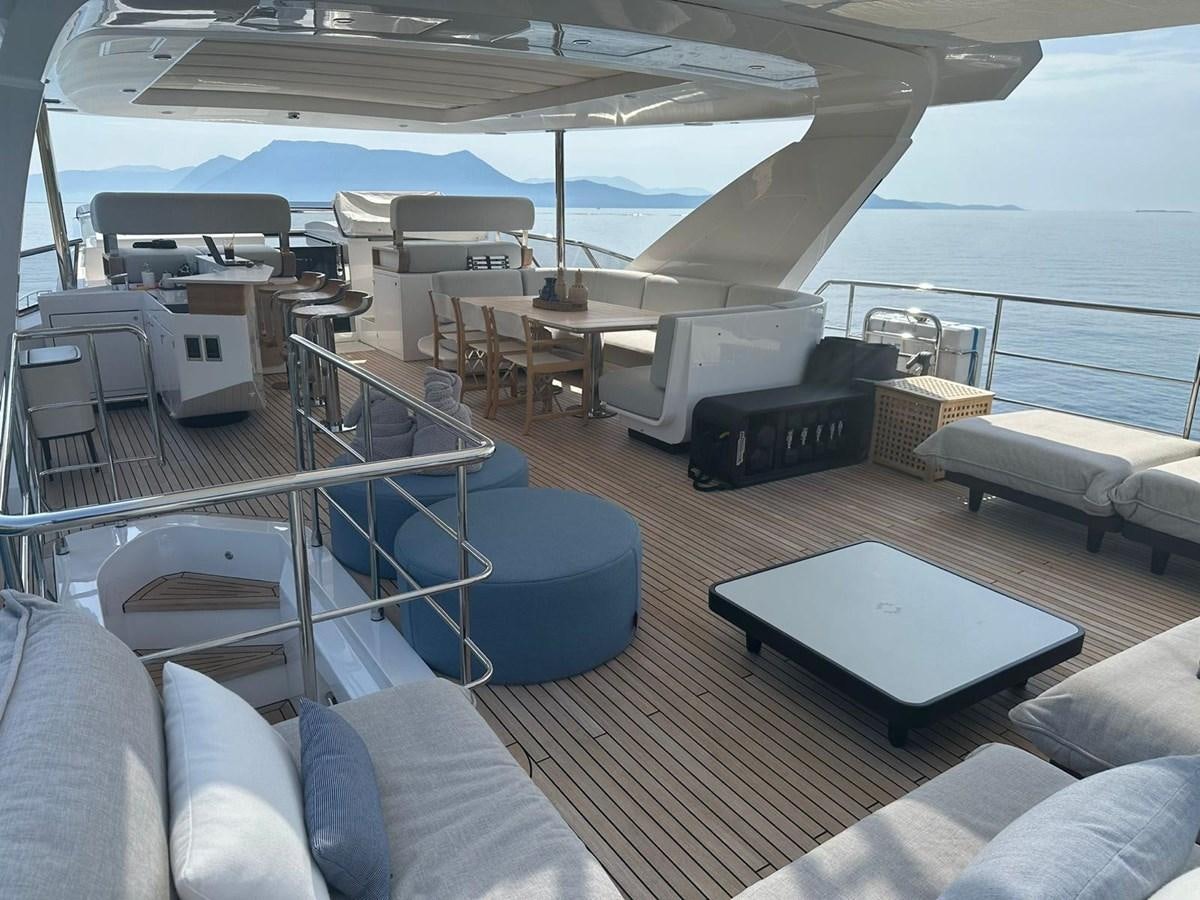 a boat with a table and chairs aboard BETTY Yacht for Sale