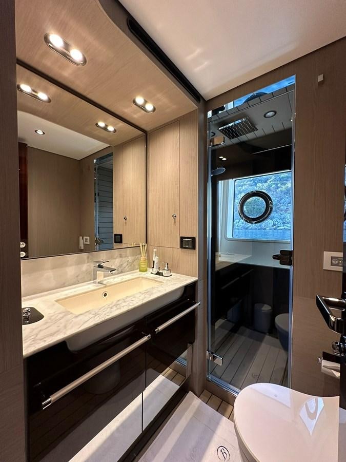 a bathroom with a large mirror aboard BETTY Yacht for Sale