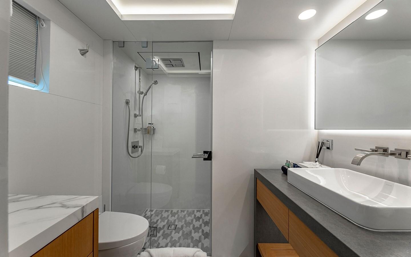 a bathroom with a glass shower aboard REVERIE Yacht for Sale