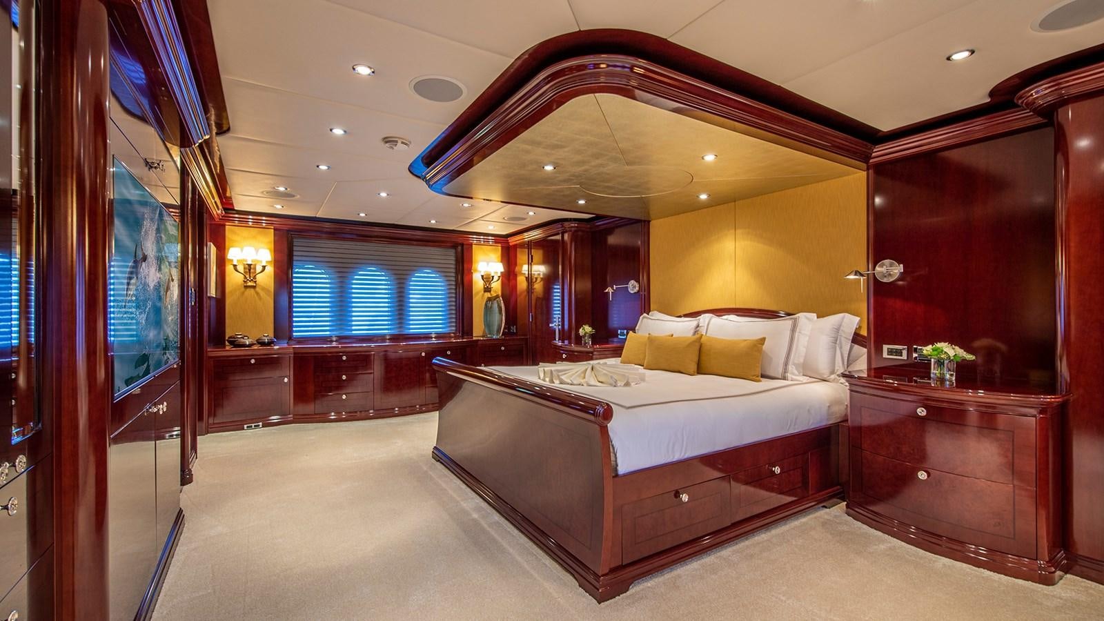 a large bedroom with a bed aboard LA DEA II Yacht for Sale
