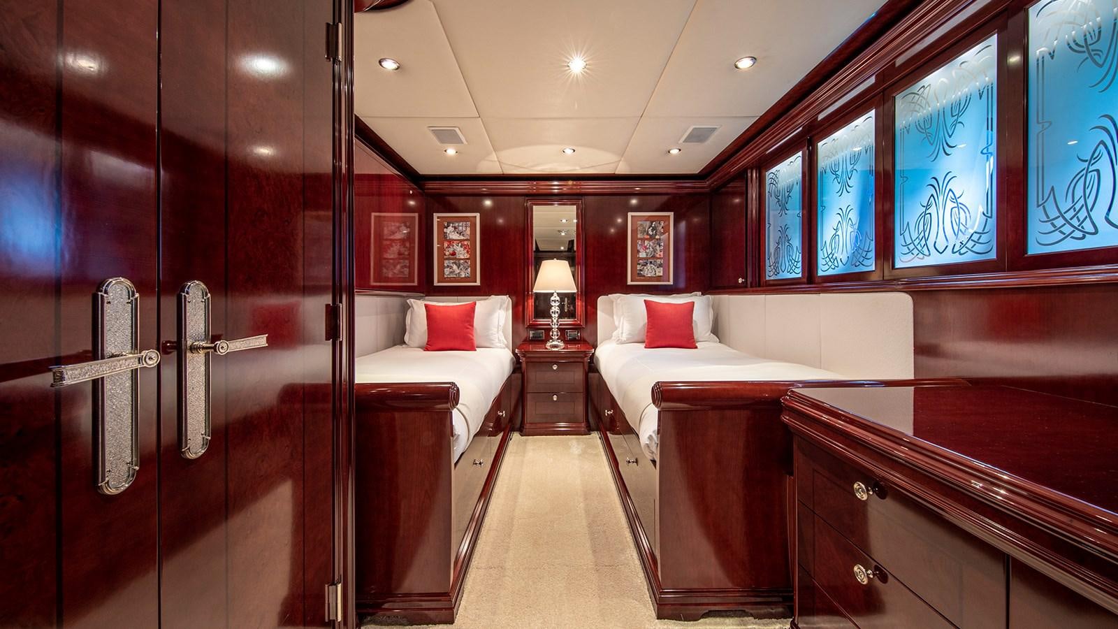 a room with a bed and a desk aboard LA DEA II Yacht for Sale