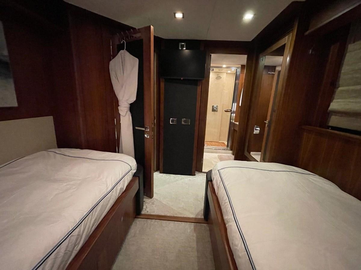 a room with beds and a closet aboard SOLARIS Yacht for Sale