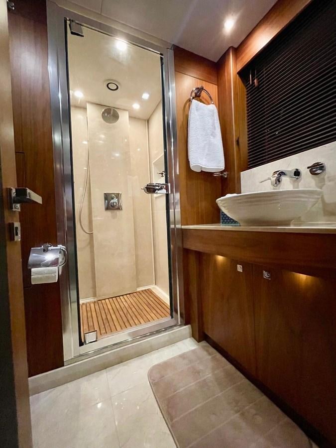 a bathroom with a shower unit and sink aboard SOLARIS Yacht for Sale