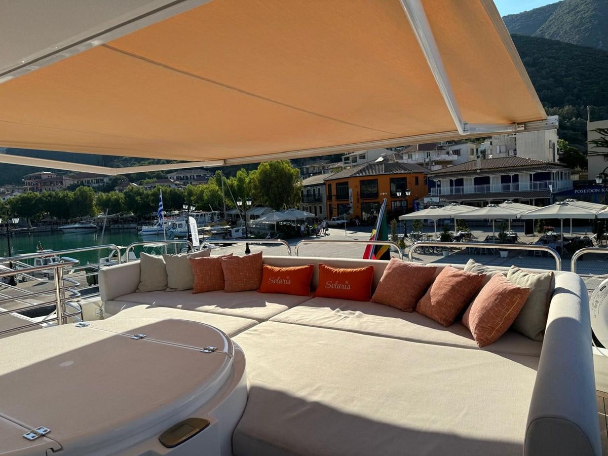 a lounge area with a large lounge chair and a large body of water aboard SOLARIS Yacht for Sale