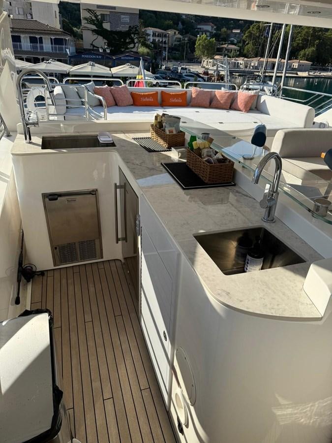 a room with a pool and a deck with chairs and tables aboard SOLARIS Yacht for Sale