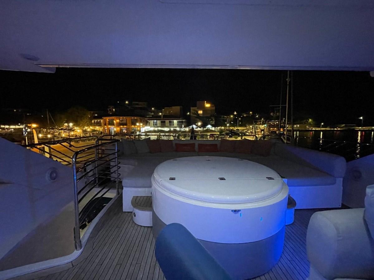 a rooftop view of a city at night aboard SOLARIS Yacht for Sale