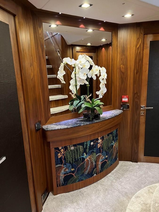 a vase of flowers on a wood shelf aboard SOLARIS Yacht for Sale
