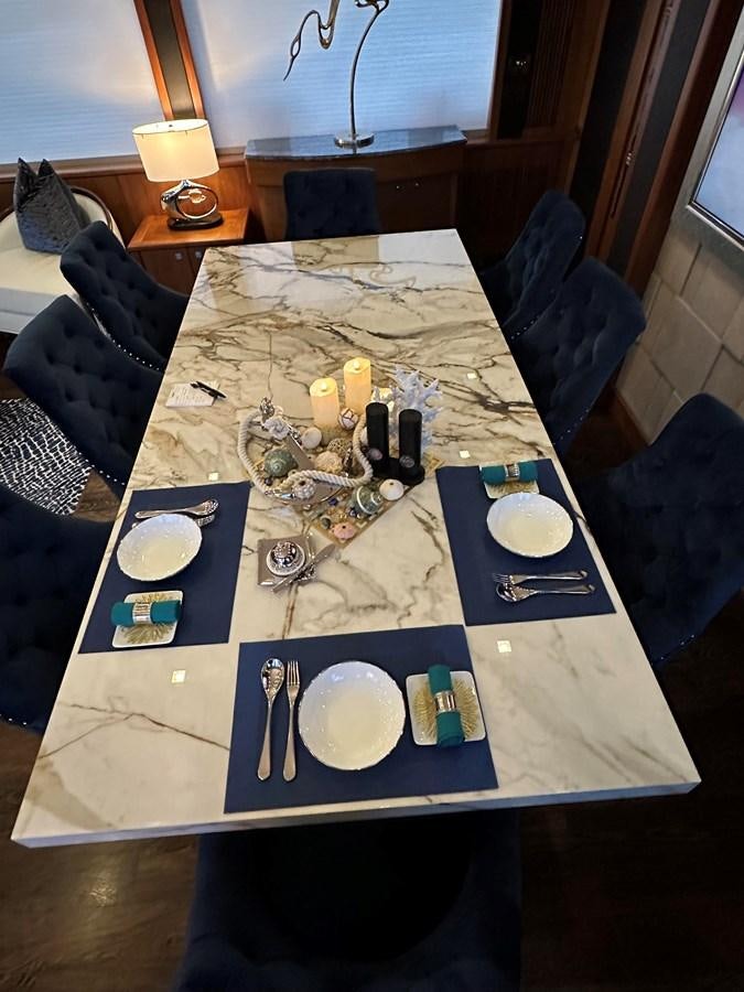 a table with plates and bottles on it aboard SOLARIS Yacht for Sale
