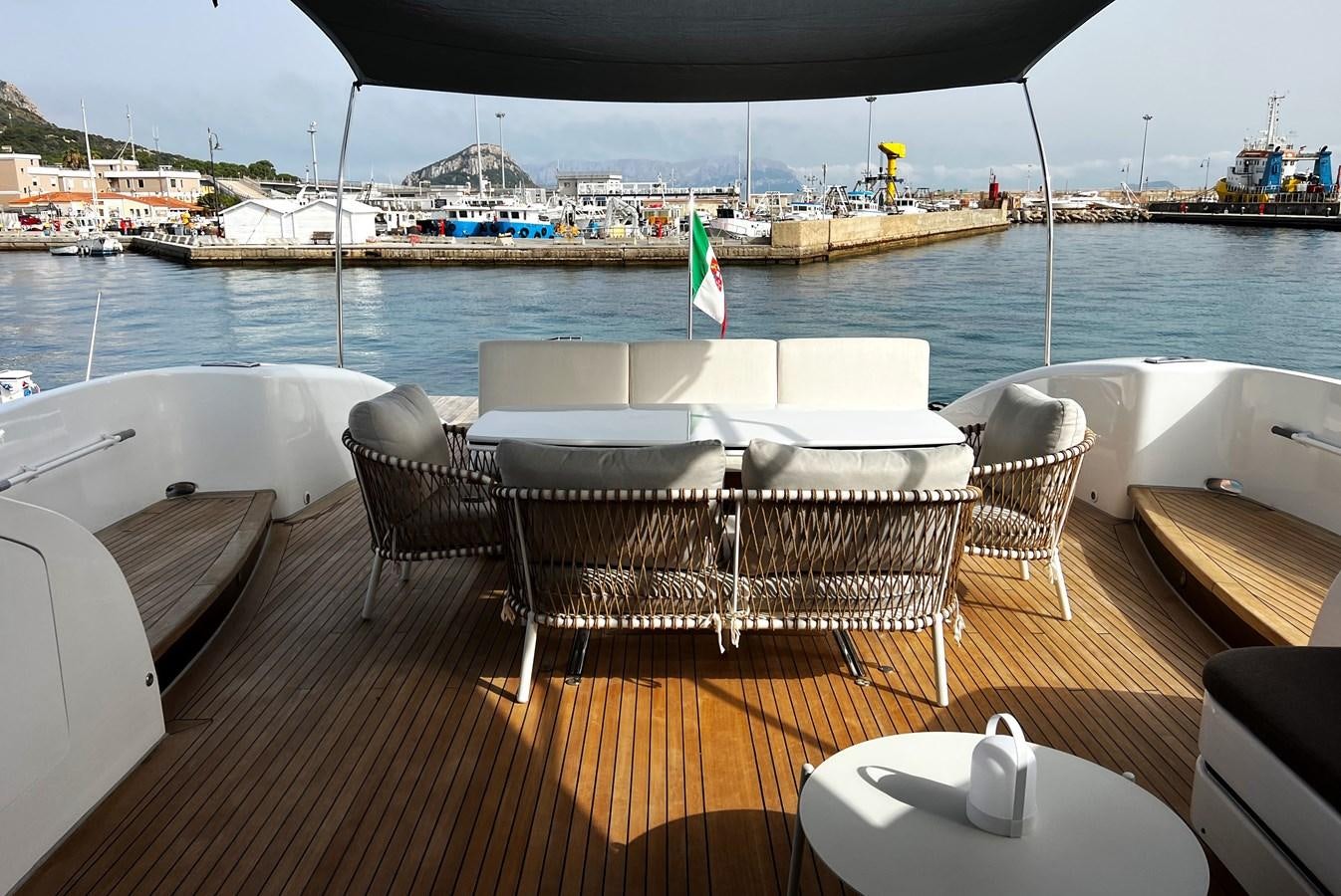 a table and chairs on a deck overlooking a body of water aboard SCORPIO Yacht for Sale
