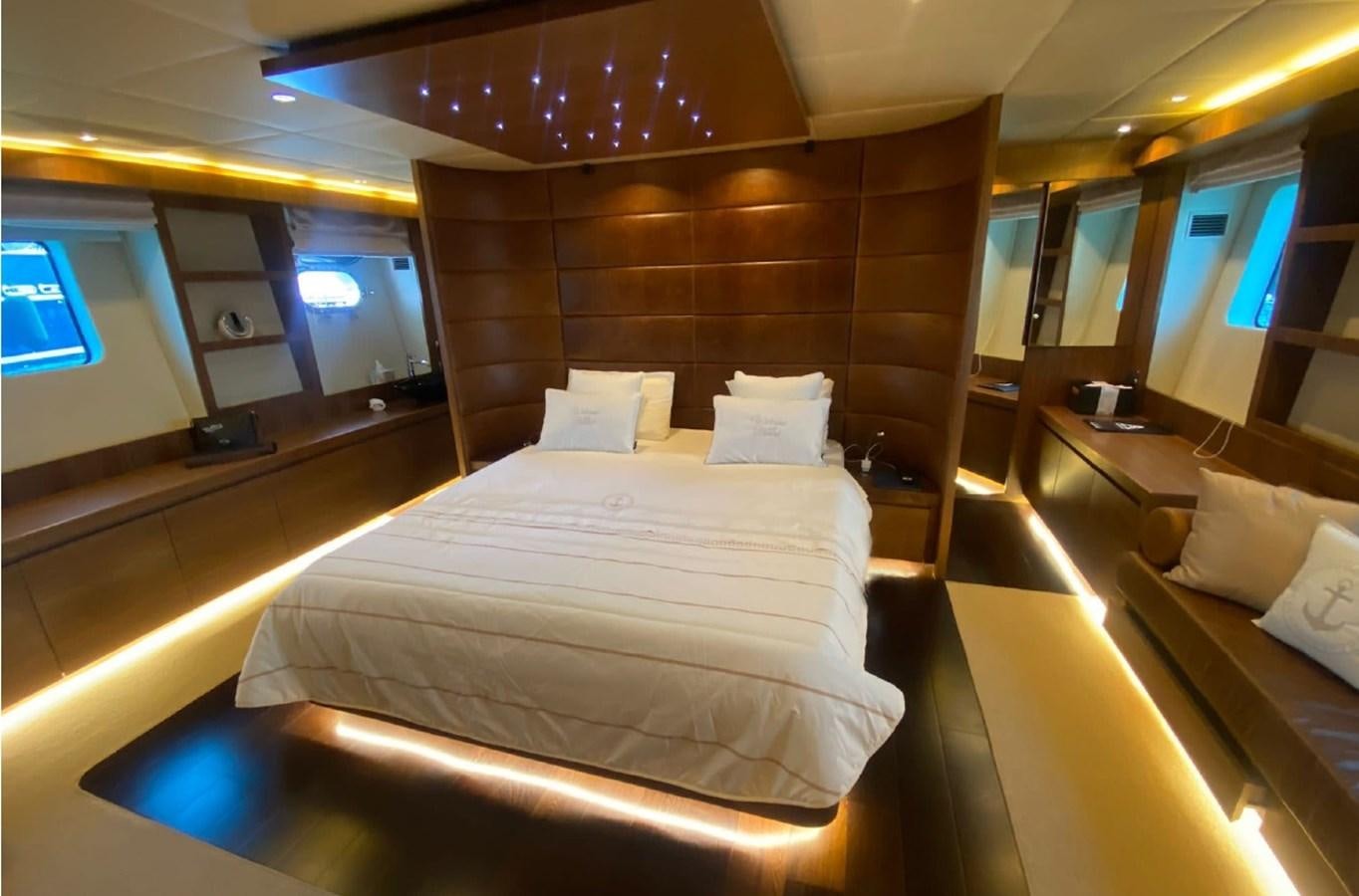 a room with a bed and a table aboard SCORPIO Yacht for Sale