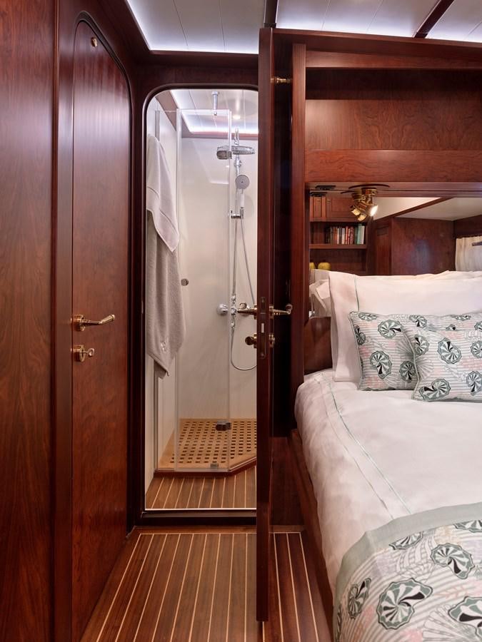 a bedroom with a bed and a door aboard KAFTAN Yacht for Sale