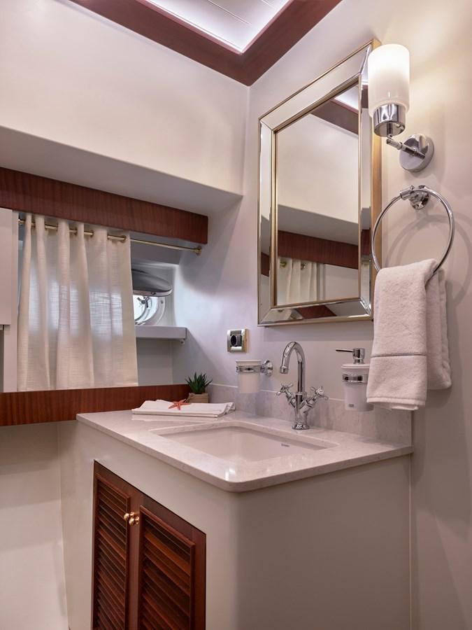a bathroom with a sink and a mirror aboard KAFTAN Yacht for Sale