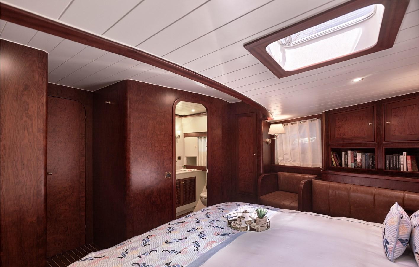 a room with a bed and a couch aboard KAFTAN Yacht for Sale