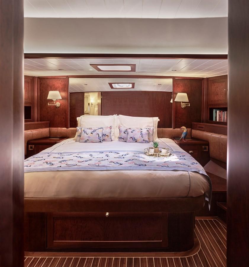 a bed with a flowered bed aboard KAFTAN Yacht for Sale