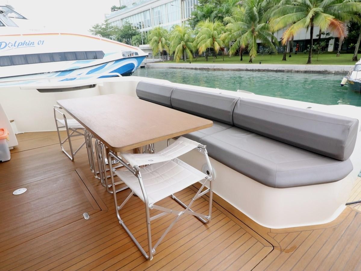 a table and chairs by a pool aboard SONIA Yacht for Sale
