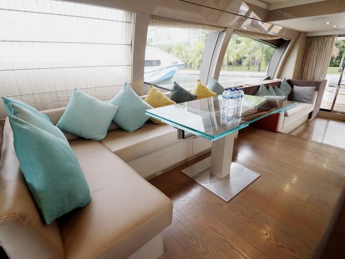 a living room with a table and couches aboard SONIA Yacht for Sale