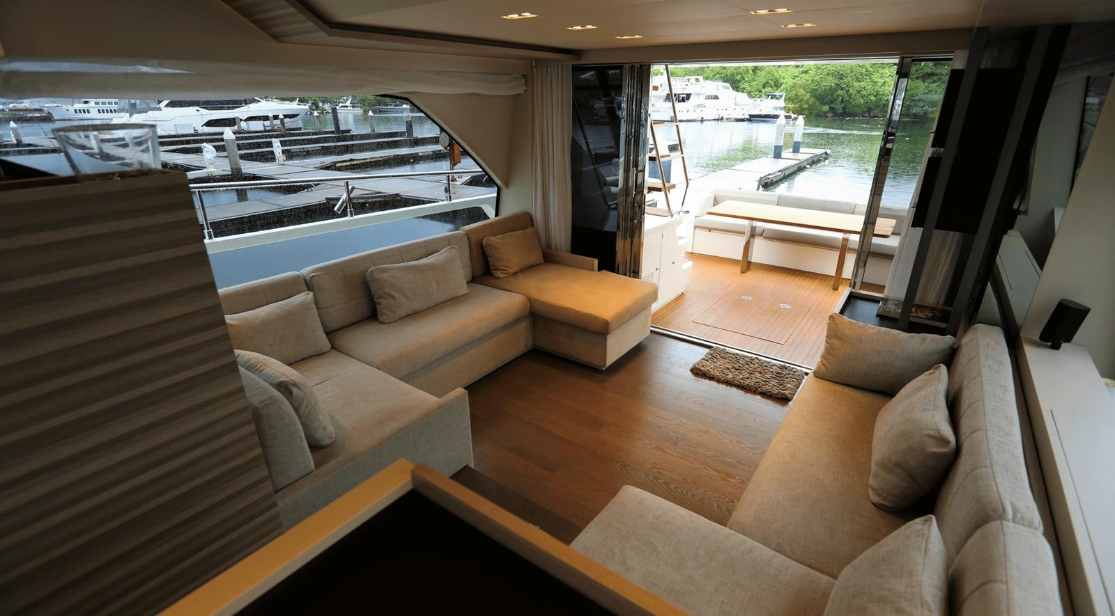 a living room with a large window aboard 2020 FERRETTI 670 Yacht for Sale