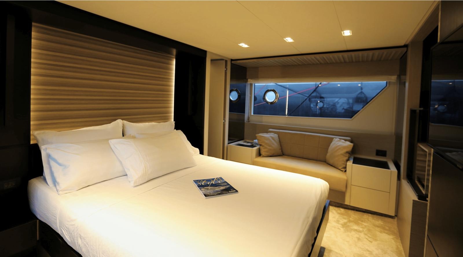 a hotel room with a bed and a couch aboard 2020 FERRETTI 670 Yacht for Sale