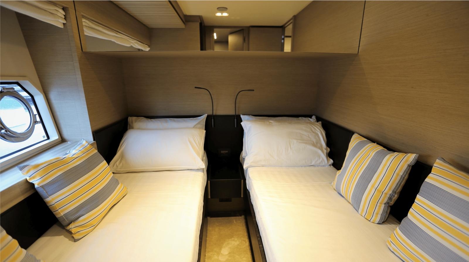 a room with beds and a window aboard 2020 FERRETTI 670 Yacht for Sale