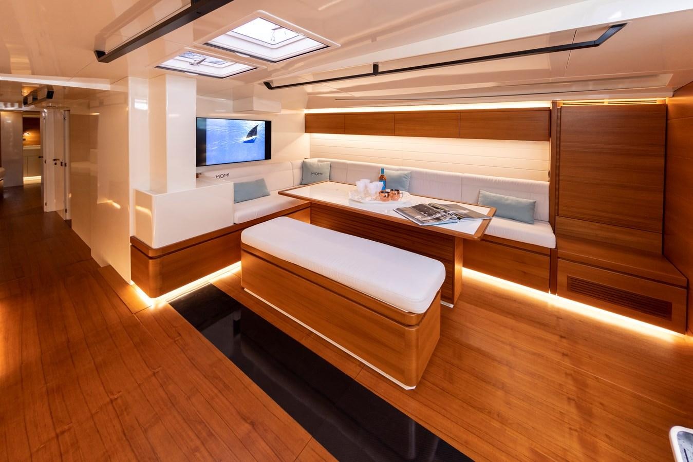 a room with a table and tv aboard MOMI Yacht for Sale