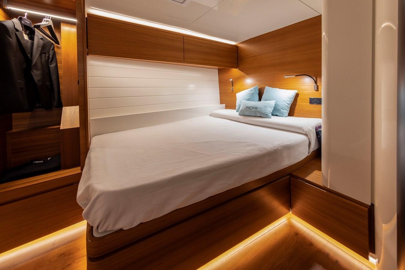 a bed with a white sheet aboard MOMI Yacht for Sale