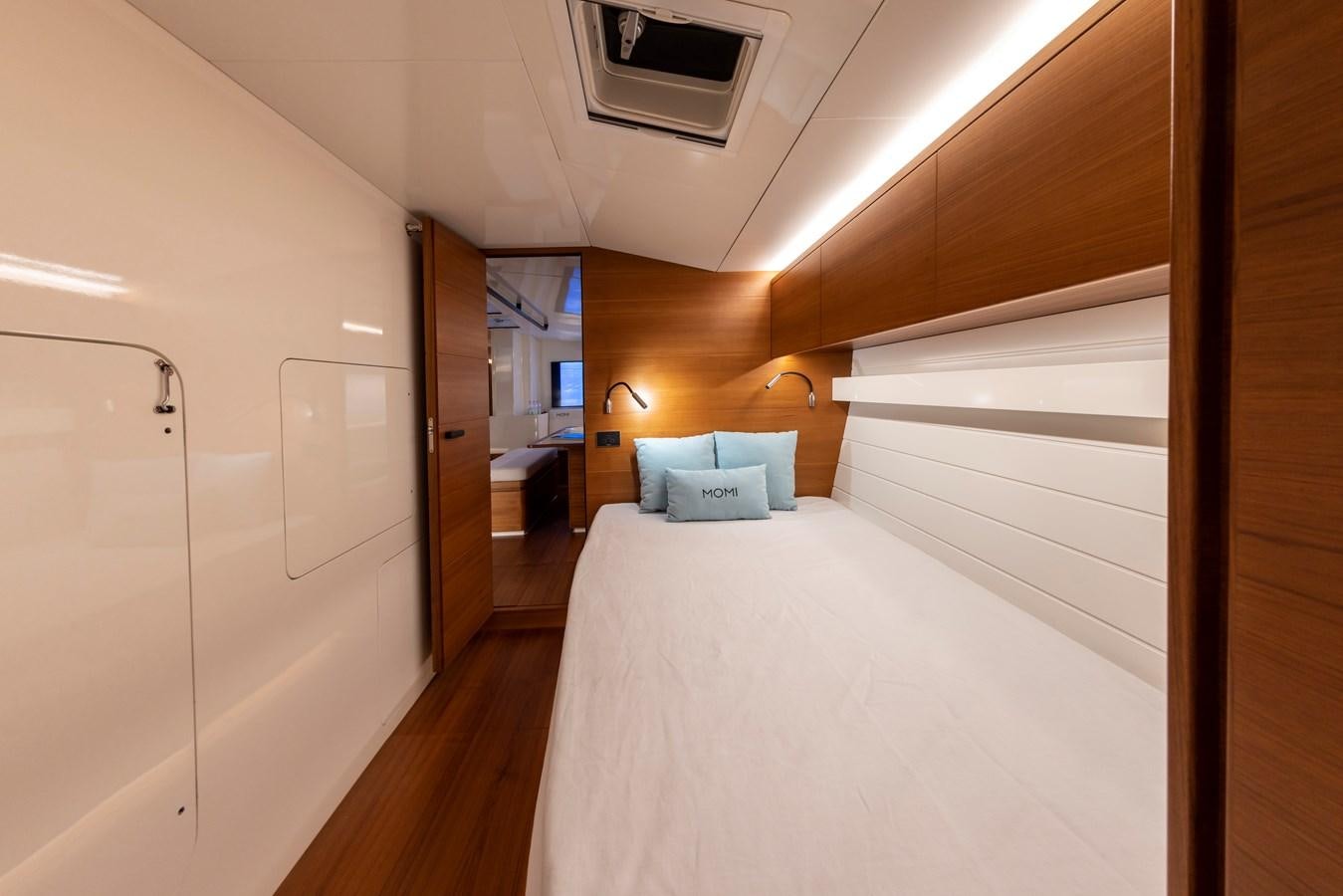 a bedroom with a bed and a closet aboard MOMI Yacht for Sale