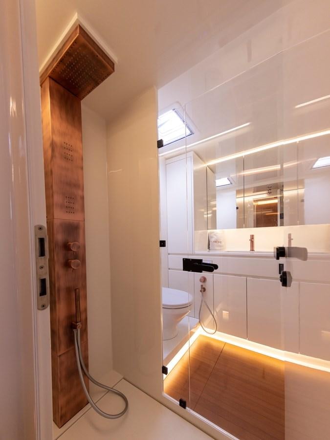 a bathroom with a shower unit aboard MOMI Yacht for Sale