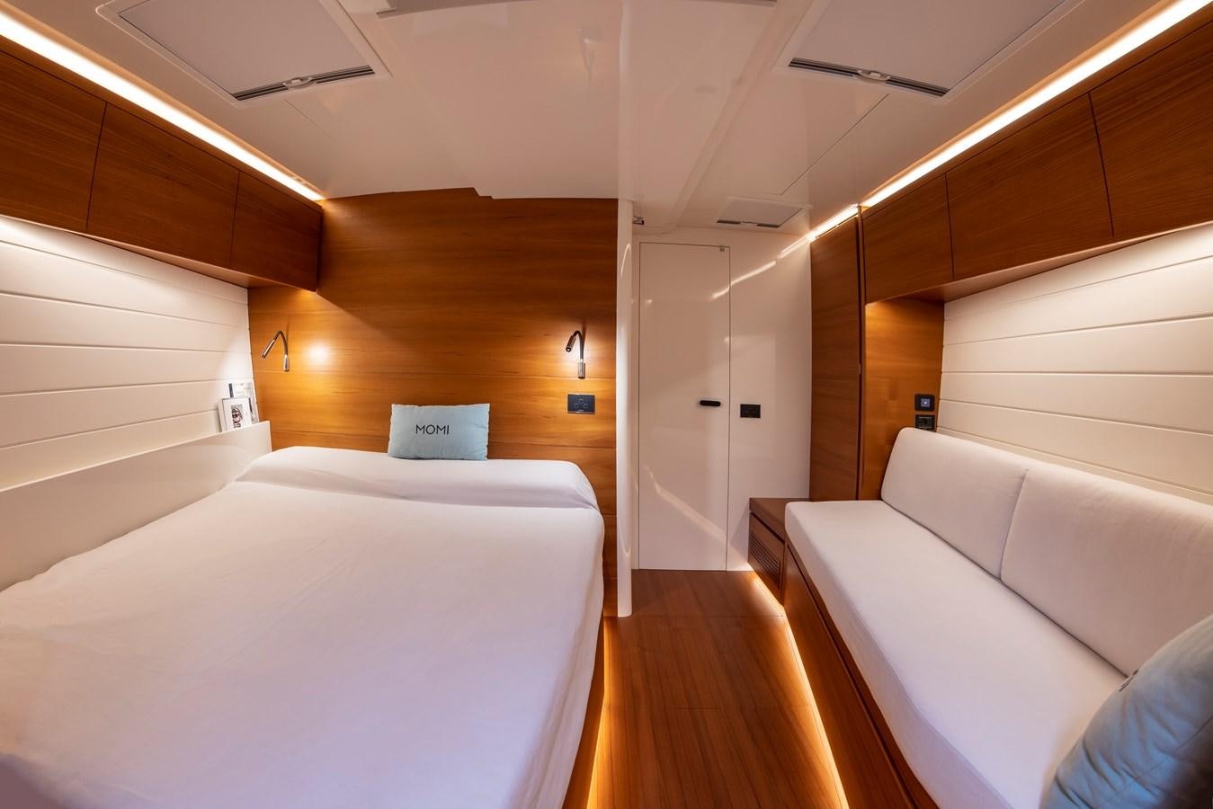 a room with a bed and a desk aboard MOMI Yacht for Sale
