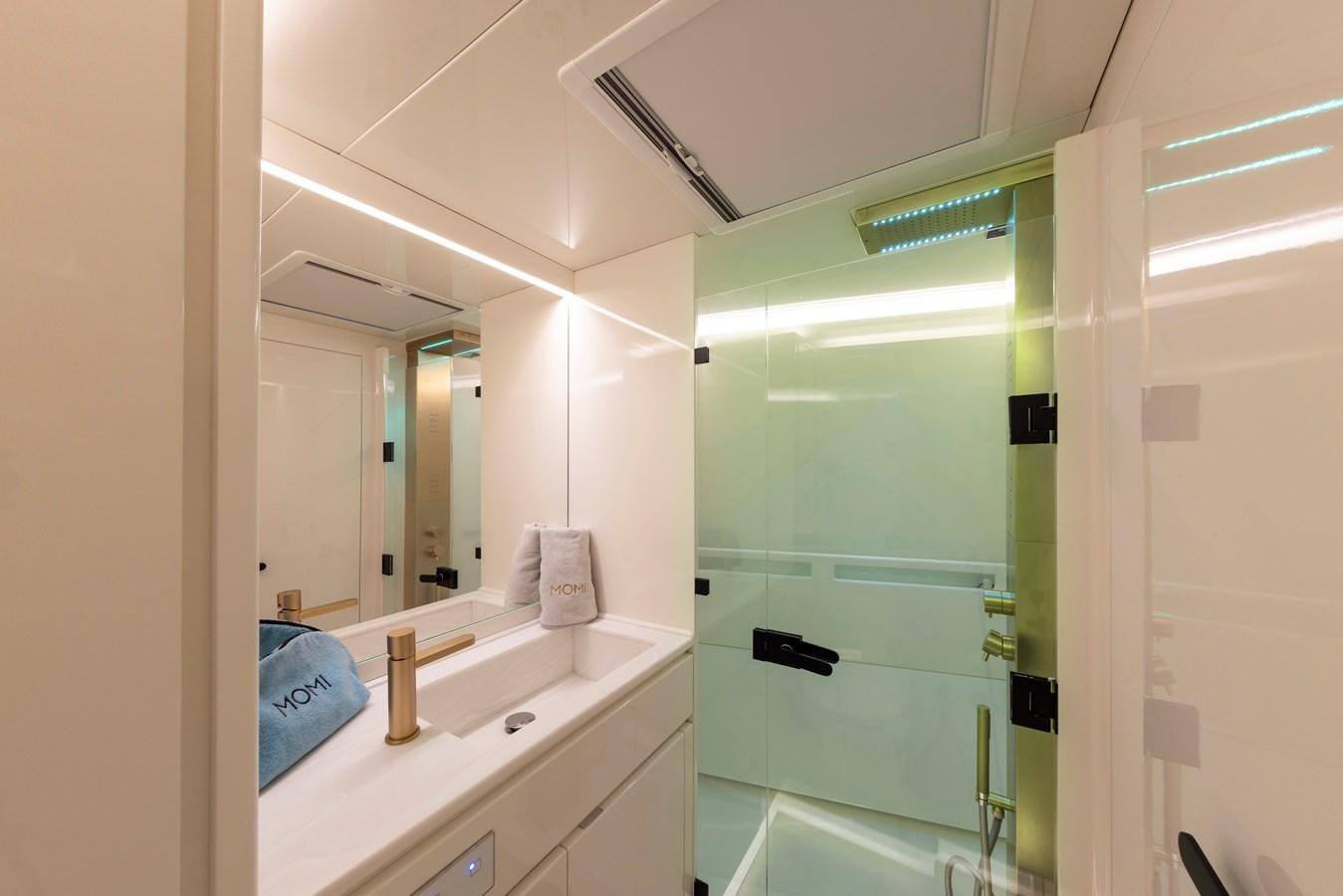 a bathroom with a glass shower aboard MOMI Yacht for Sale