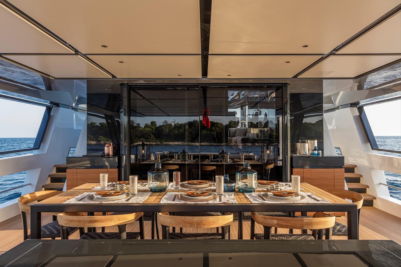 a large kitchen with a table and chairs aboard ARCADIA SHERPA 80 Yacht for Sale