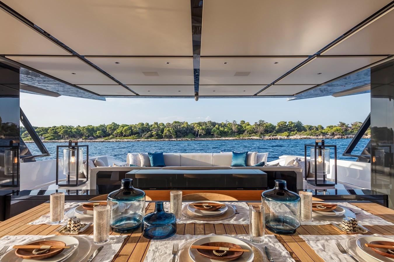 a table with glasses and plates on it aboard ARCADIA SHERPA 80 Yacht for Sale