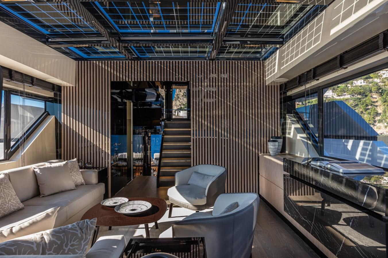 a room with a couch and a table and a large window aboard ARCADIA SHERPA 80 Yacht for Sale