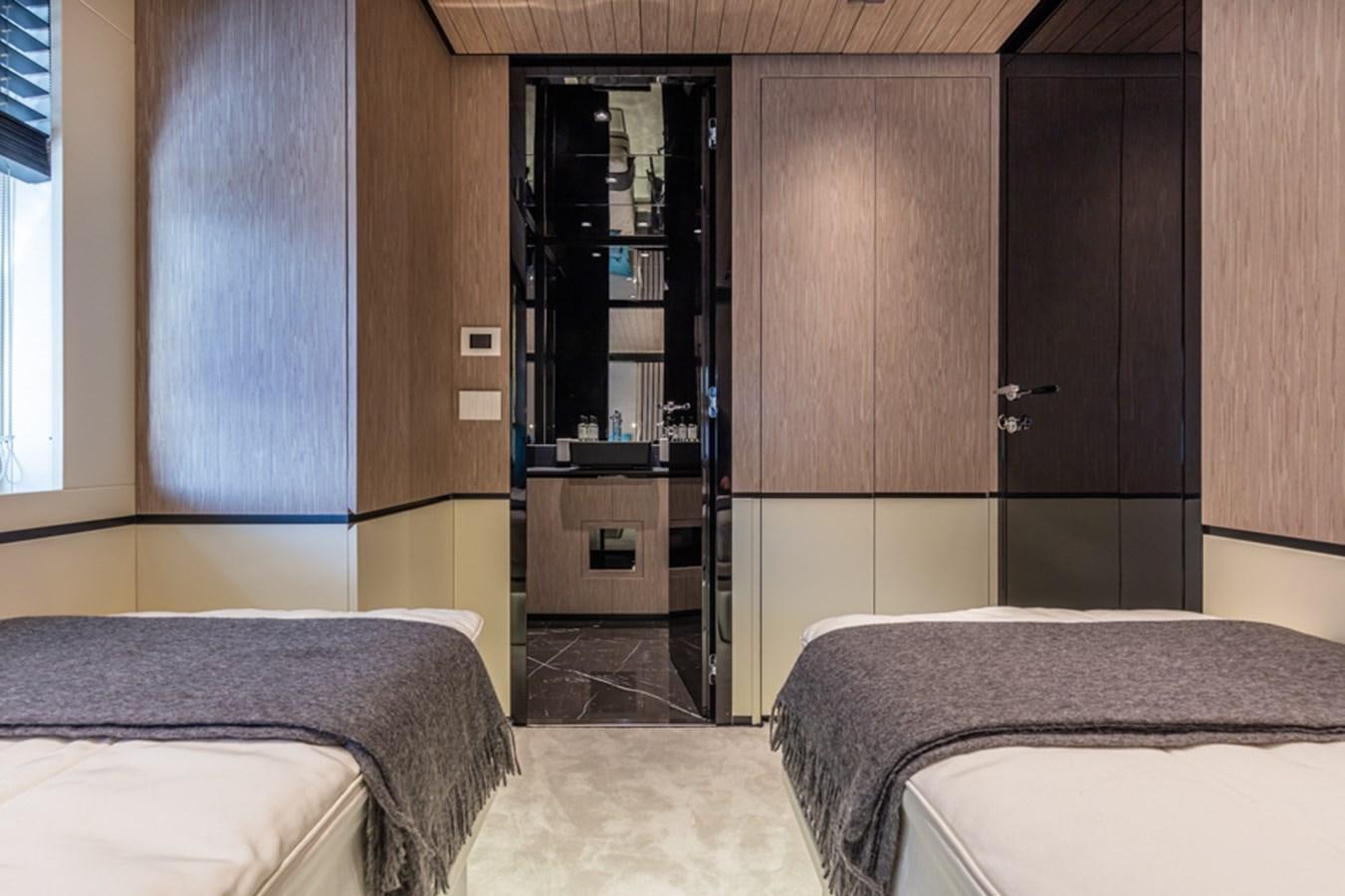 a room with a bed and a closet aboard ARCADIA SHERPA 80 Yacht for Sale