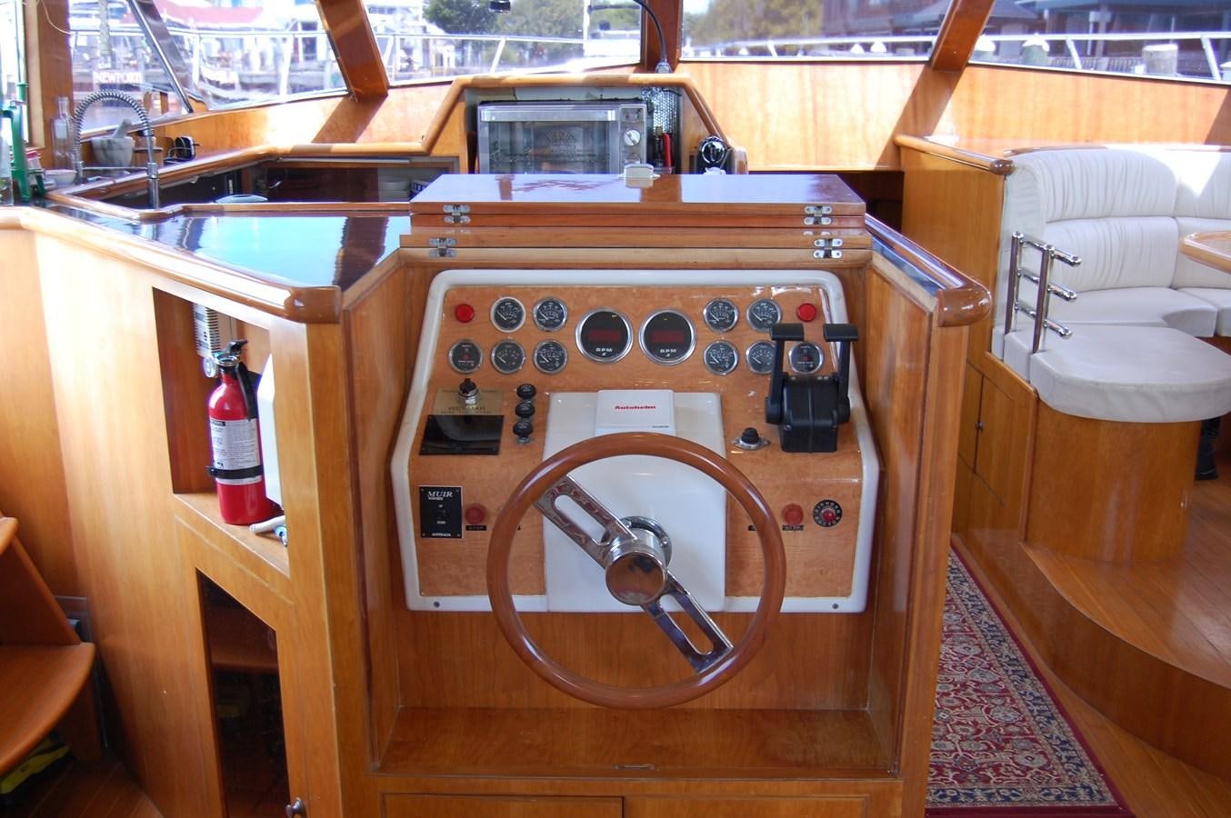 a wooden cabinet with a fan and a wood box with knobs aboard SOTITO Yacht for Sale