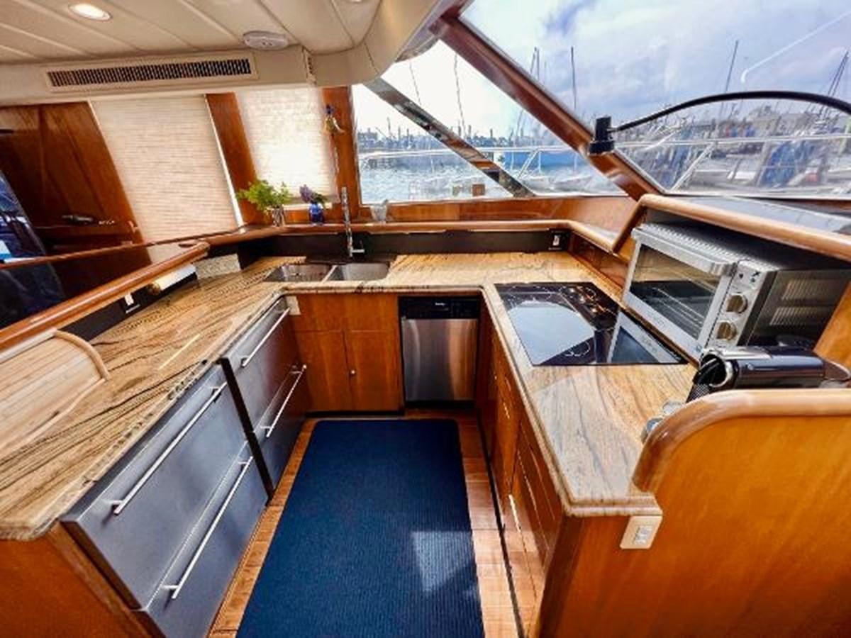 a large kitchen with wooden cabinets aboard SOTITO Yacht for Sale