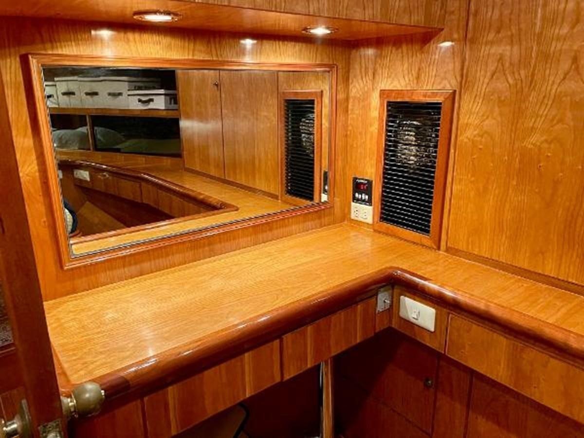 a wooden cabinet with a glass door aboard SOTITO Yacht for Sale