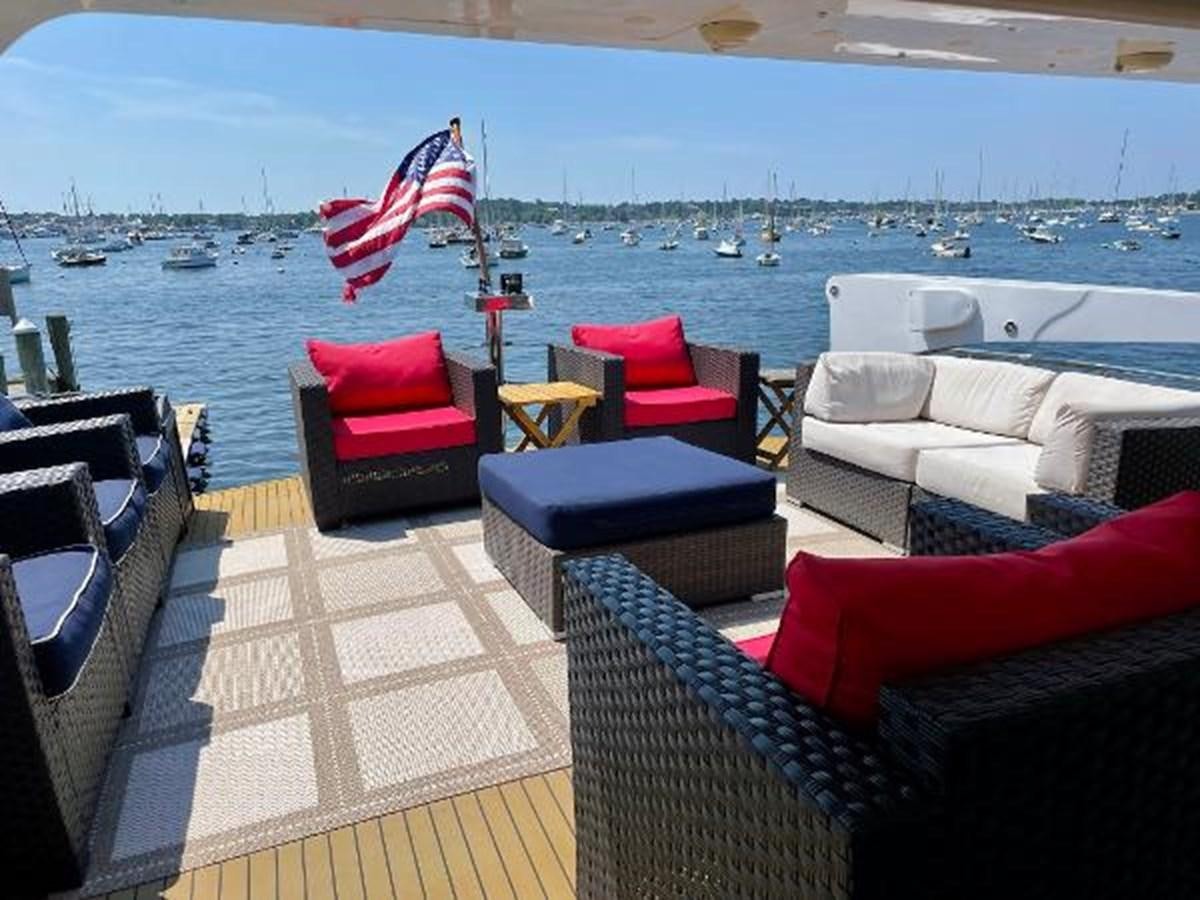 a deck with chairs and a flag aboard SOTITO Yacht for Sale
