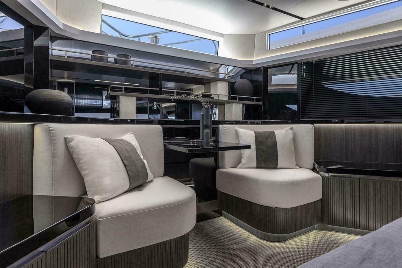 a room with couches and a table aboard PEARL 72 INDULGENCE Yacht for Sale