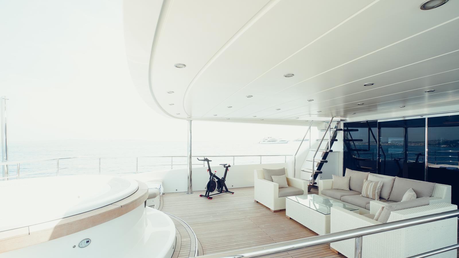 a room with a couch and a ladder aboard TATIANA I Yacht for Sale