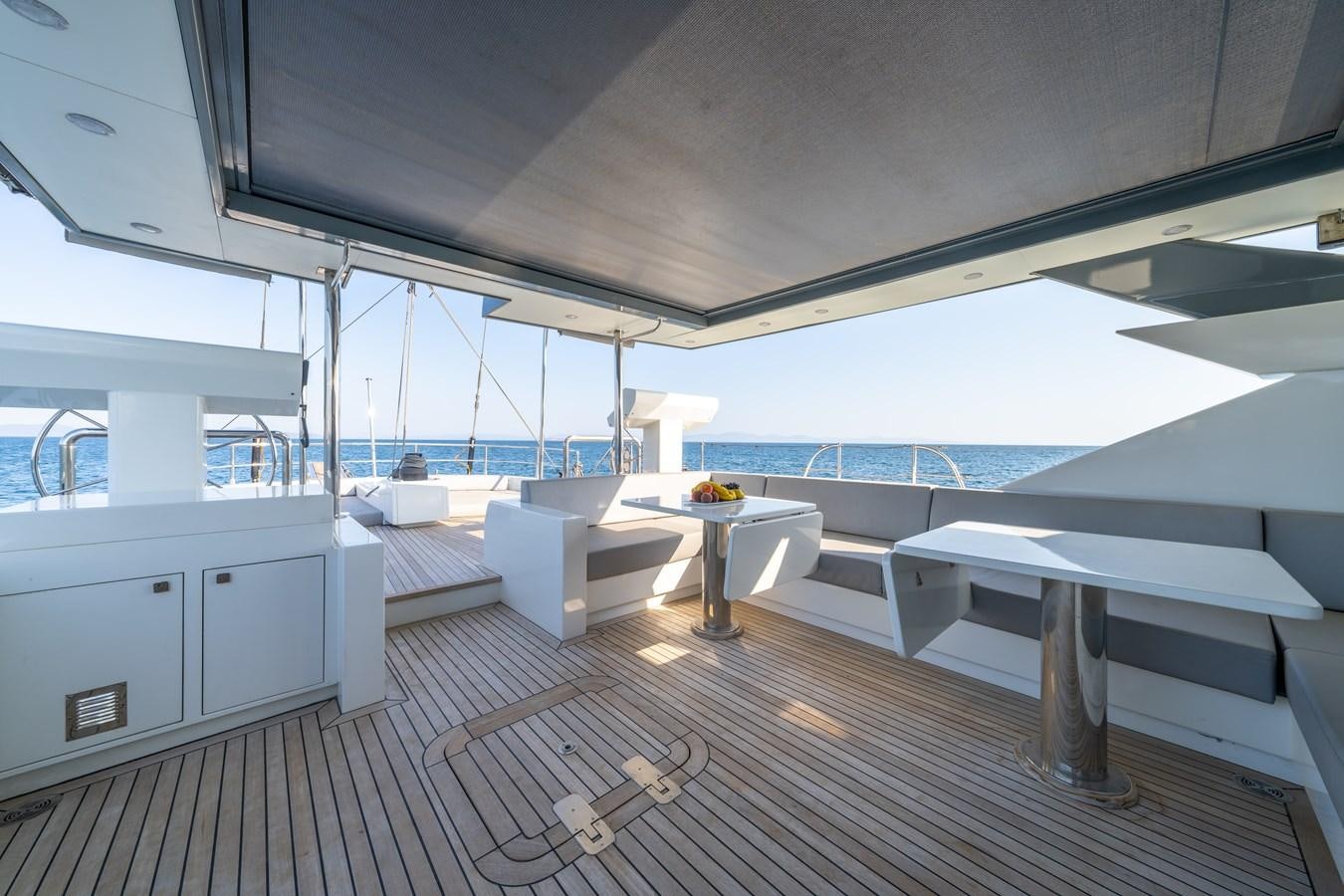 a room with a table and chairs aboard JASMINA III Yacht for Sale