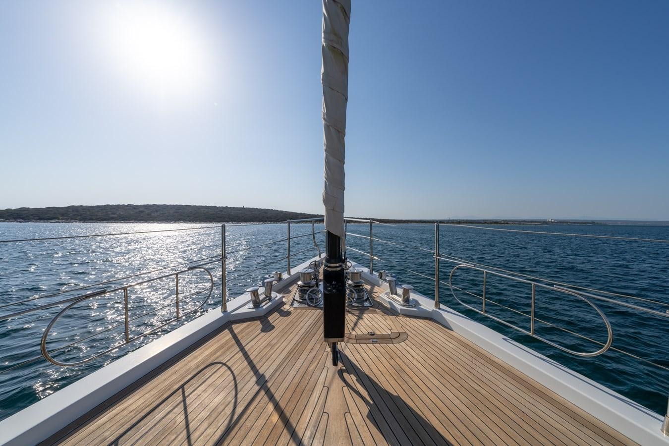 a wooden dock with a pole on it and a body of water in the background aboard JASMINA III Yacht for Sale