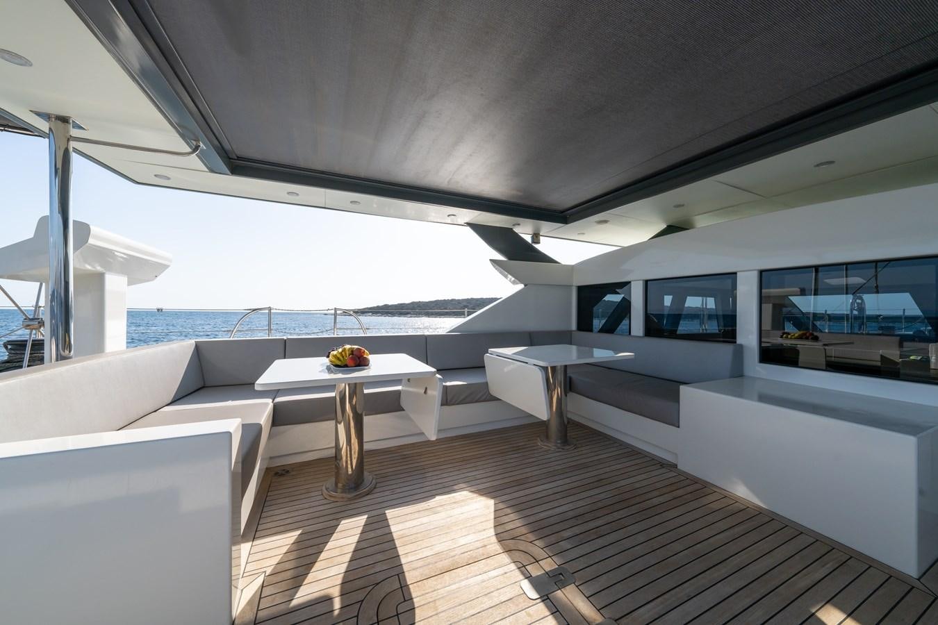 a room with a table and a couch aboard JASMINA III Yacht for Sale